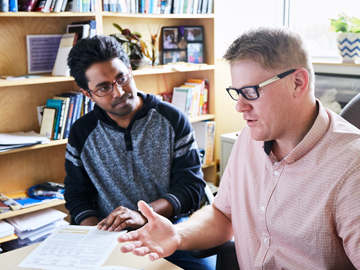 student and professor working together in office