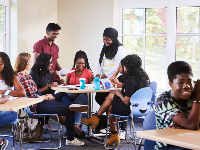 students sitting around table talking
