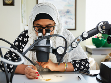 student at microscope