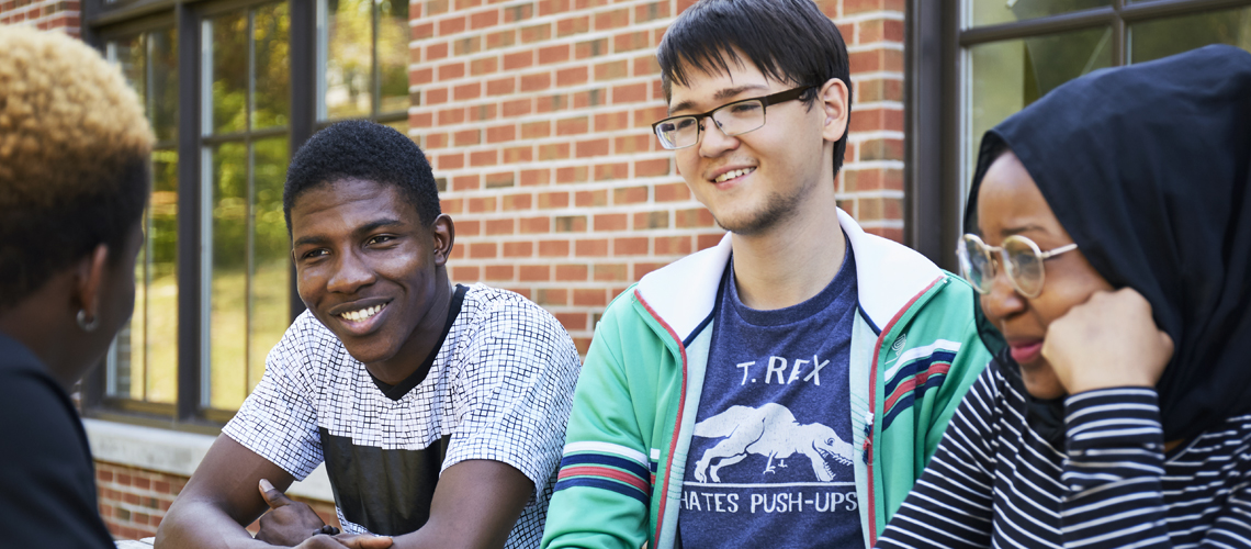students sitting outside talking