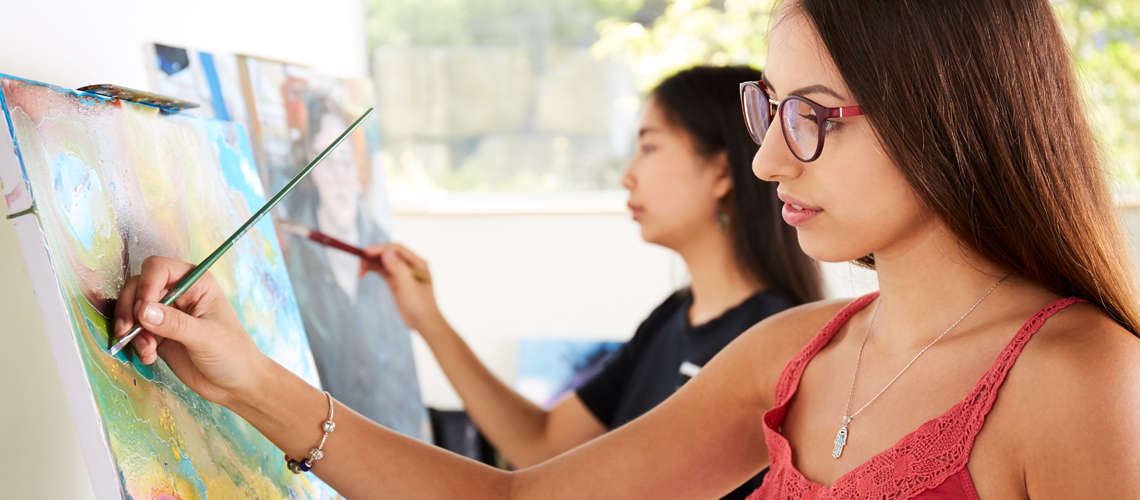 students painting canvasses