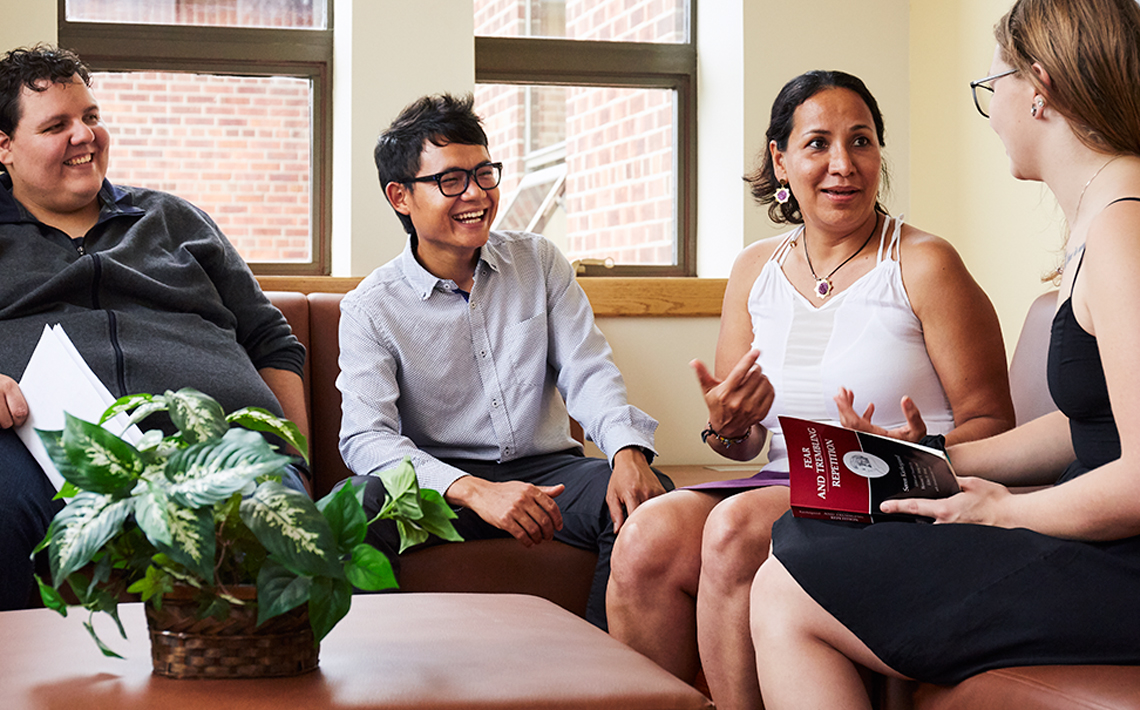 students and professor conversing