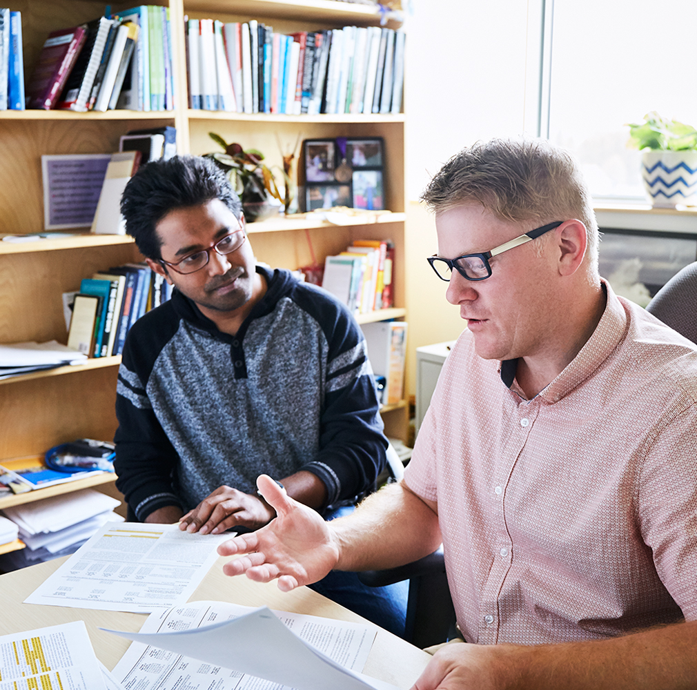 student and professor conversing