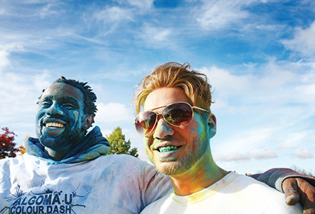 students covered in coloured powder