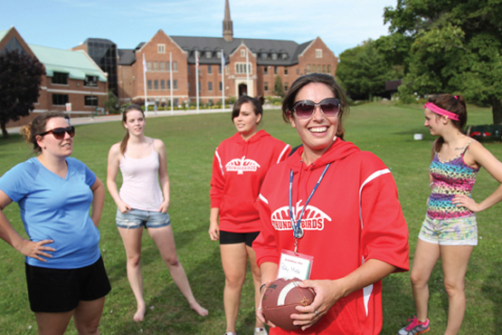 students playing games in the front lawn of Shingwauk hall