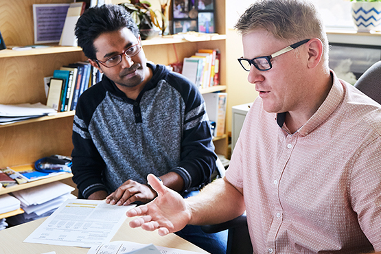 student and professor conversing