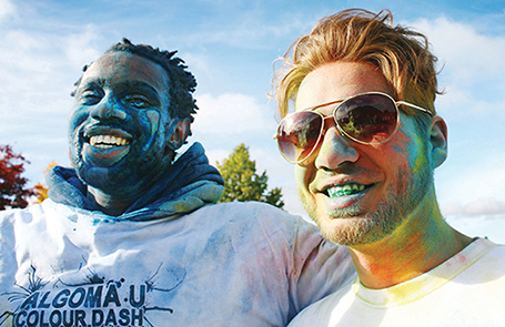students covered in colourful powder