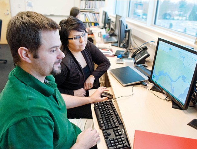 student and professor in computer lab