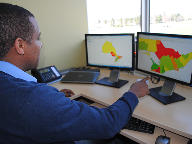 faculty working on map on computer