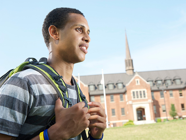 student walking in front of university building