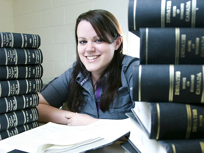 student surrounded by textbooks