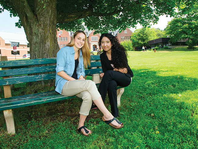 students sitting on park bench