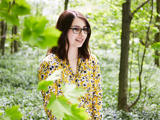 student standing in forest