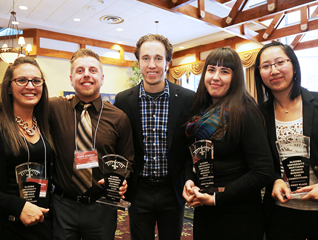 students holding trophies