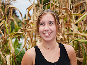 student in corn field
