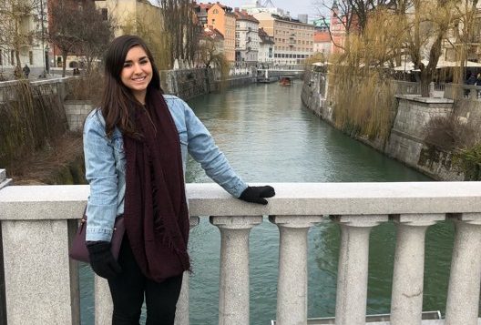 student in front of canal