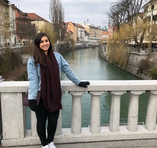 student in front of canal