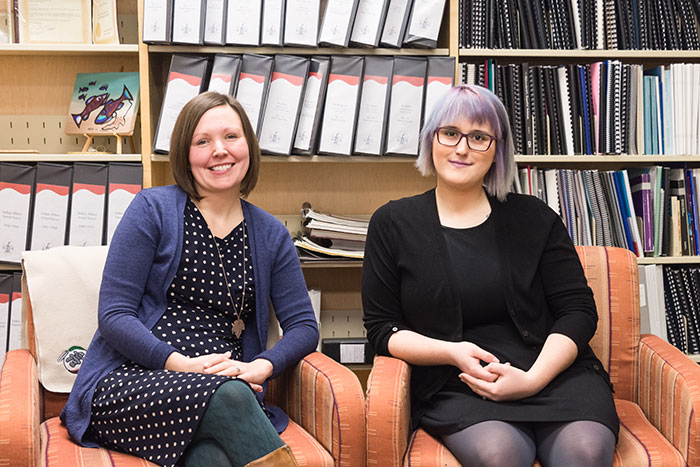 staff sitting and smiling in library