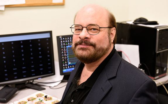 man sitting in computer lab
