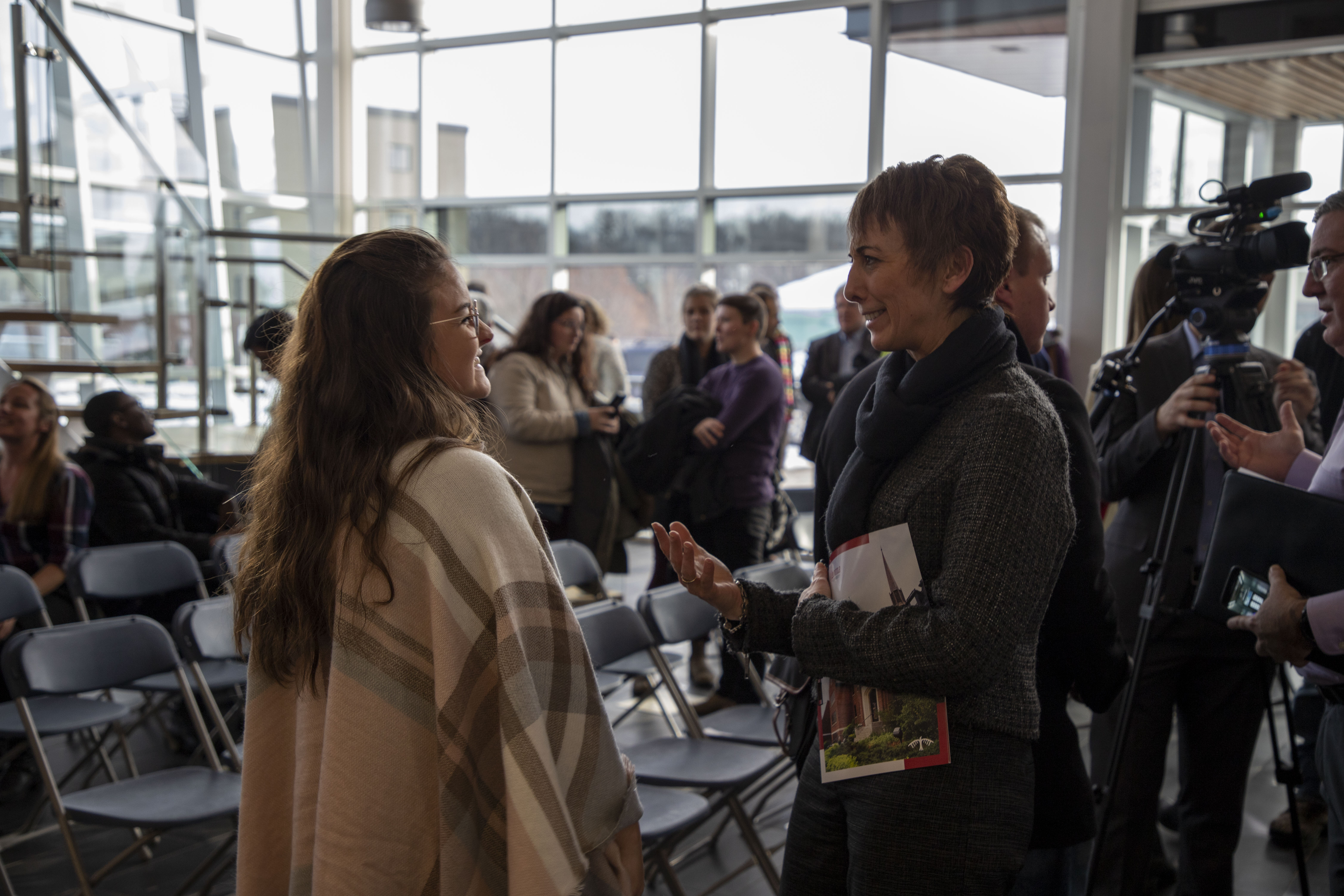 student talking with president Asima Vezina