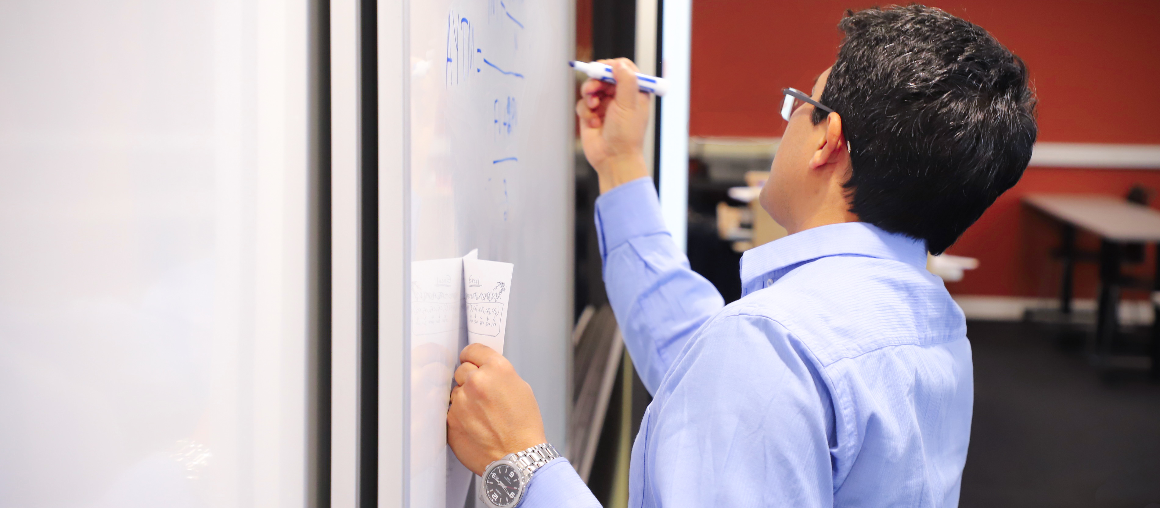 Professor writing on board