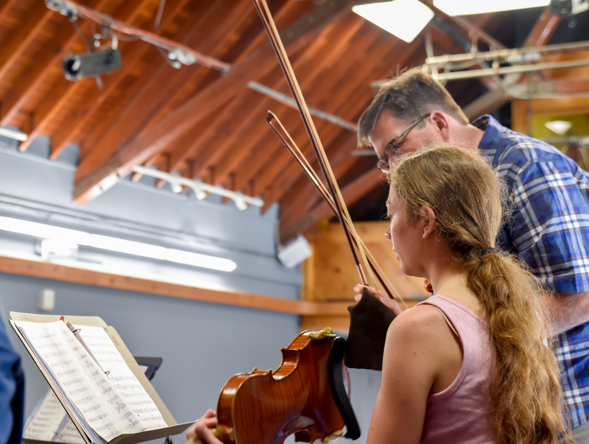 instructor giving music lessons to student