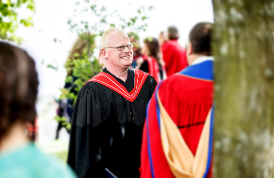 faculty member talking to a student during convocation