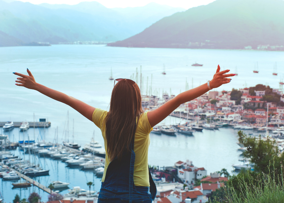 student photo visiting another country looking over mountains and water