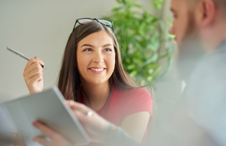 student with pen discussing with someone