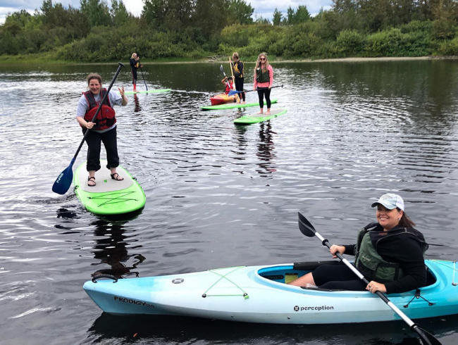 student paddle boarding