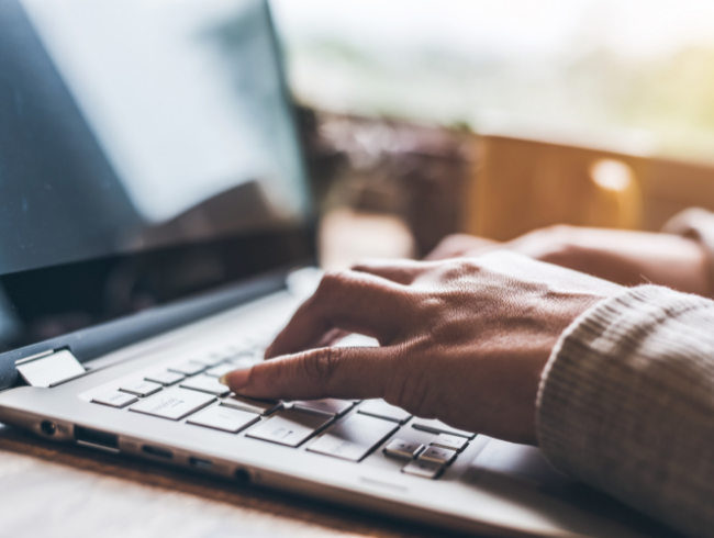 person typing on laptop