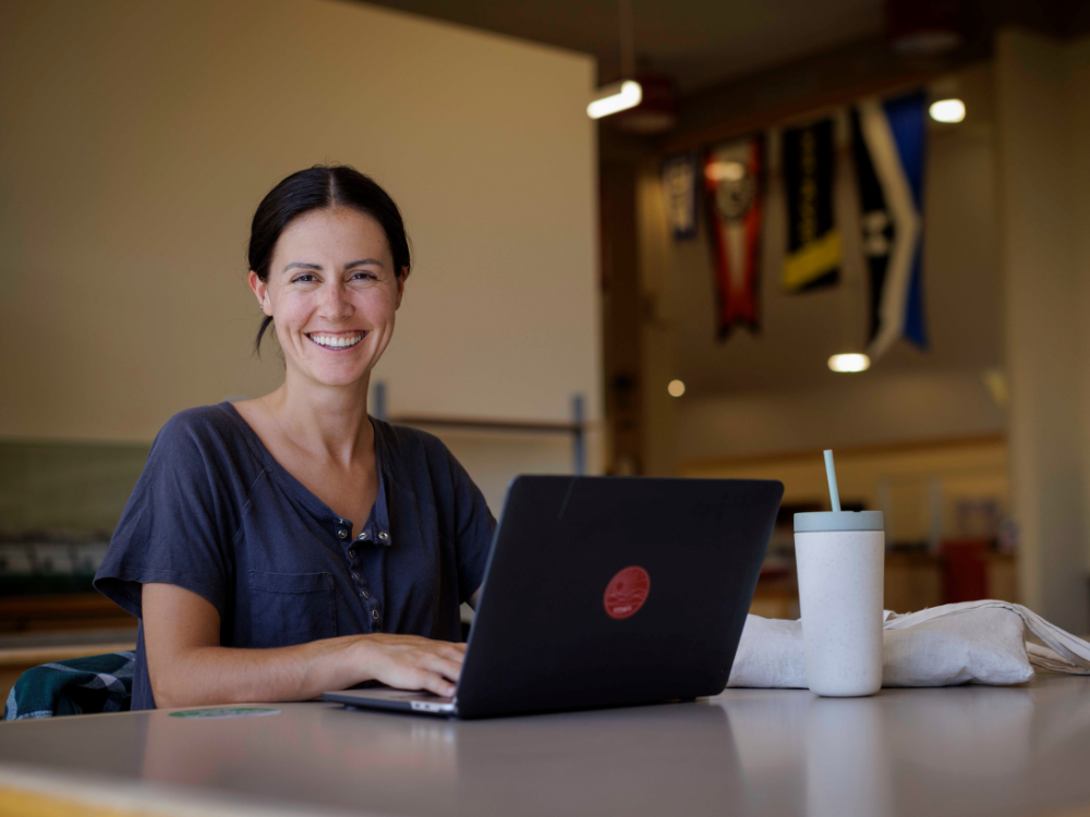 student smiling with laptop