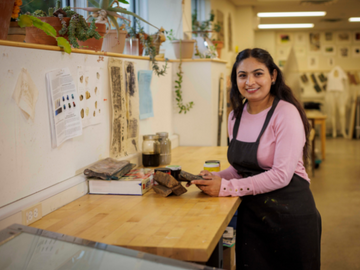 student smiling in art studio